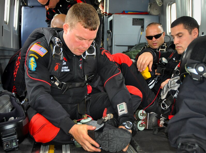 An Army Black Dagger parachute team prepares in the back of a C-145 Skytruck prior to a jump May 17 at Duke Field, Fla.  The team is composed of volunteers from throughout the Army special operations community. Their mission is to perform live aerial demonstrations in support of Army special operations community relations and recruiting. (U.S. Air Force photo/Dan Neely) 