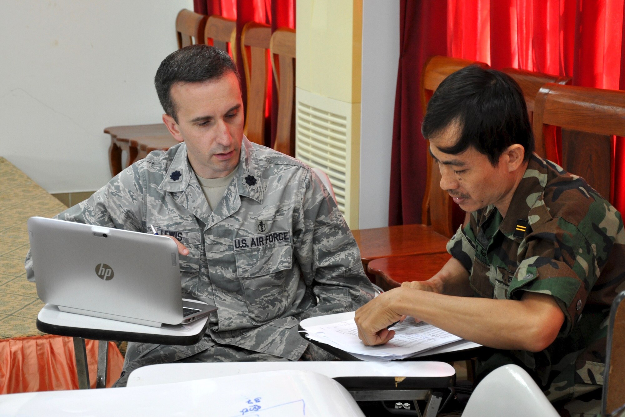 U.S. Air Force Lt. Col. Paul Lewis talks with Royal Cambodian Air Force Maj. Lt. Kim Thou about treatment of patients during a subject matter expert exchange focused on humanitarian assistance and disaster response June 9, 2016 in Kampot Province, Cambodia. Exchanges such as these help build partner capacity and bolsters each nation’s ability to work side-by-side, which is particularly important when faced with responding to a natural disaster. Lewis is a U.S. Air Force Preventive Medicine Physician deployed from the Defense Health Agency, Va., and Thou is a physician with the Cambodian Ministry of National Defense. (U.S. Air Force photo by Capt. Susan Harrington)
