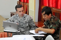 U.S. Air Force Lt. Col. Paul Lewis talks with Royal Cambodian Air Force Maj. Lt. Kim Thou about treatment of patients during a subject matter expert exchange focused on humanitarian assistance and disaster response June 9, 2016 in Kampot Province, Cambodia. Exchanges such as these help build partner capacity and bolsters each nation’s ability to work side-by-side, which is particularly important when faced with responding to a natural disaster. Lewis is a U.S. Air Force Preventive Medicine Physician deployed from the Defense Health Agency, Va., and Thou is a physician with the Cambodian Ministry of National Defense. (U.S. Air Force photo by Capt. Susan Harrington)