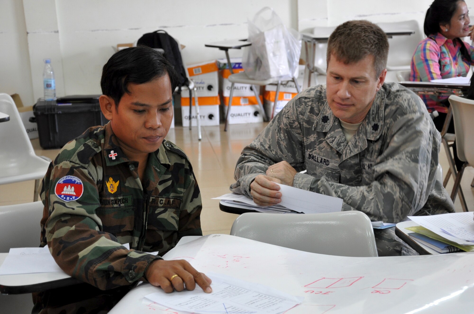 U.S. Air Force Lt. Col. Timothy Ballard listens as Royal Cambodian Armed Forces Khun Sokpech describes his plan for patient care and treatment during a natural disaster response scenario June 9, 2016 in Kampot Province, Cambodia. The scenario was part of a subject matter expert exchange focused on humanitarian assistance and disaster response held during Pacific Angel 16-2, a total force, joint and combined humanitarian assistance mission led by the U.S. Air Force. Events such as this aid in the Cambodian Armed Forces and the provincial hospital and health clinic staff in being better-prepared and able to care for citizens as well be as ready to overcome a natural disaster. Ballard is a U.S. Air Force Preventive Medicine Physician deployed from the U.S. Air Force Medical Support Agency / Defense Institute for Medical Operations at Lackland Air Force Base, Texas. (U.S. Air Force photo by Capt. Susan Harrington)  