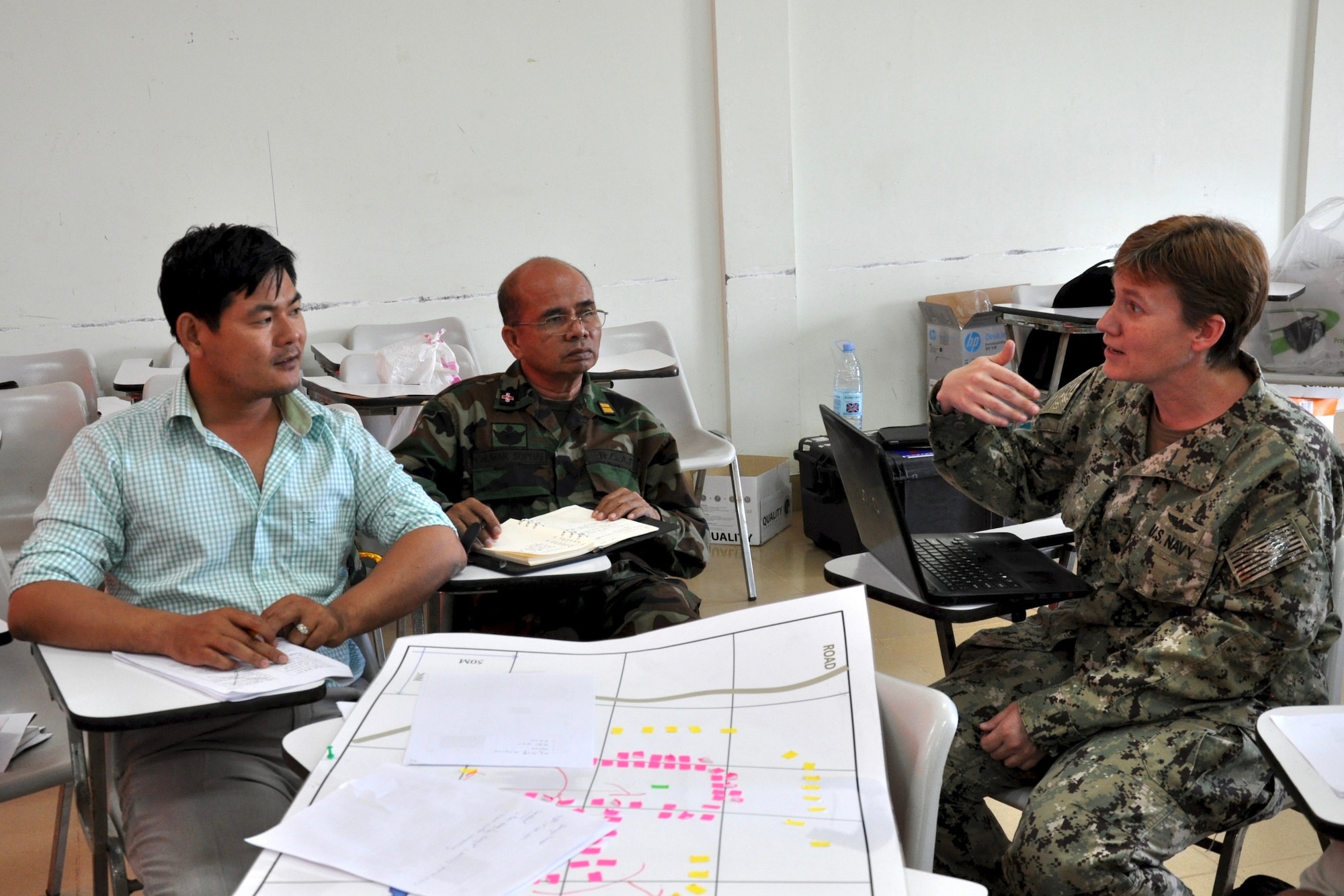U.S. Navy Cmdr. Tammy Servies discusses a patient treatment scenario with Dr. Kim Seng Chawn and Dr. (Col.) Mak Sophai during a subject matter expert exchange focused on humanitarian assistance and disaster response June 9, 2016 in Kampot Province, Cambodia. The exchange was part of Pacific Angel 16, a U.S. Air Force led humanitarian assistance and civil military operation mission that builds partner capacity through medical and health outreach, engineering civic projects and subject matter exchanges. Participants included medical professionals from the U.S. Air Force, U.S. Navy, Australian Defense Forces, Royal Cambodian Armed Forces and Kampot Provincial Hospital and Health Center. Servies is a U.S. Navy Preventive Medicine Physician deployed from Navy Environmental and Preventive Medicine Unit 6 as part of Pacific Angel 16-2. (U.S. Air Force photo by Capt. Susan Harrington)