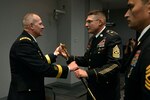 Army Lt. Gen. Timothy Kadavy, left, director of the Army Guard, passes the noncommissioned officer's sword to Command Sgt. Maj. Christopher Kepner, center, the incoming command sergeant major of the Army National Guard, during a Change of Responsibility Ceremony, June 8, 2016 in Arlington, Va. The passing of the NCO sword is a symbolic representation of the assumption of responsibilty. 