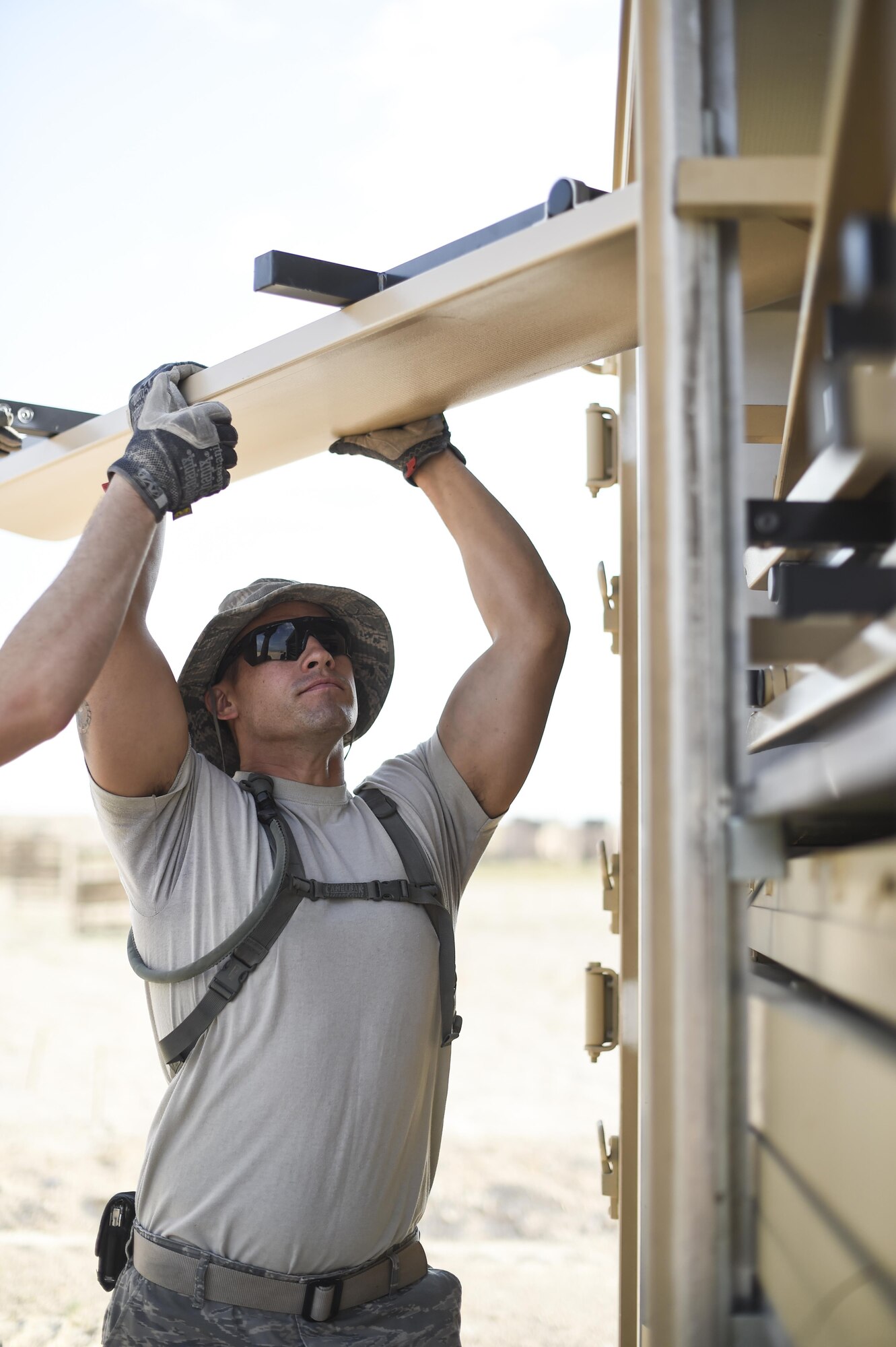 Tech. Sgt. Benjamin, 49th Civil Engineer Squadron unloads benches used for seating inside a dining facility being built during a three day joint training exercise at Holloman Air Base, N.M. on june 7. The joint exercise brought together Airmen from the 49th Materiel Maintenance Group and the 49th Civil Engineer Squadron to form the Base Expeditionary Airfield Resources team. The purpose of this exercise is to keep all Airmen trained and ready to set up and maintain worldwide deployable assets. (Last names being withheld due to operational requirements. U.S. Air Force Photo by Staff Sgt. Stacy Moless)