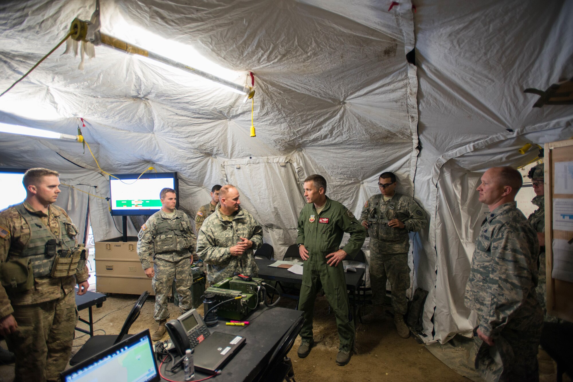 U.S. Air Force Col. Patrick McAtee, the Virginia Air National Guard’s 192nd Operations Group commander out of Joint Base Langley-Eustis, Va., serving on temporary duty as the deployed forces commander for RED FLAG-Alaska (RF-A) 16-2, center, is briefed on operations by U.S. Army commanders from the 1st Battalion, 24th Infantry Regiment, Fort Wainwright, Alaska, June 8, 2016, while visiting the Joint Pacific Alaska Range Complex (JPARC) during RF-A 16-2. The JPARC provides a realistic training environment and allows commanders to train for full spectrum engagements, ranging from individual kills to complex, large-scale joint engagements. (U.S. Air Force photo by Senior Airman Joshua Weaver/Released)