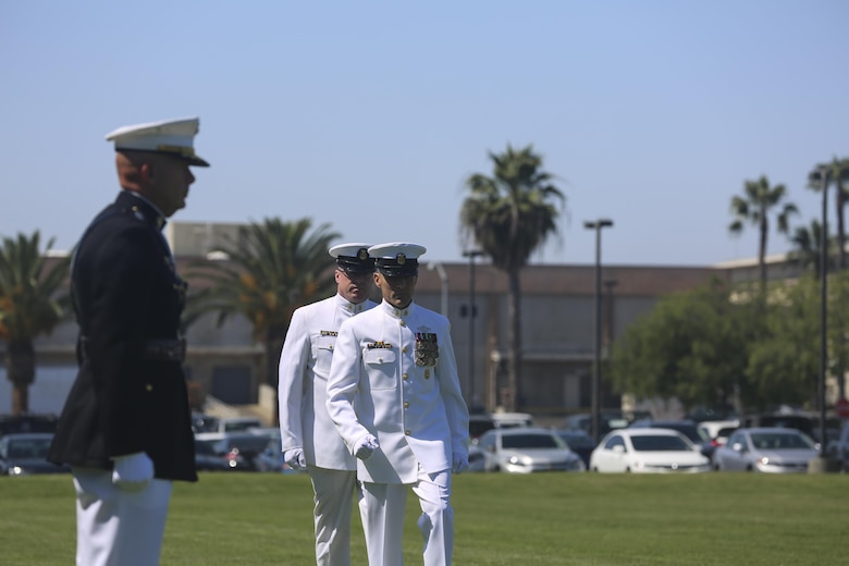 MARINE CORPS BASE CAMP PENDLETON, Calif. - Master Chief Petty Officer Frank Dominguez, front, and Master Chief Petty Officer Michael Smith, march to Lt. Gen. David H. Berger, commanding general of I Marine Expeditionary Force, for the change of charge and retirement ceremony for Smith on Camp Pendleton June 3, 2016. As a veteran of 3 armed conflicts, Smith is retiring after 30 years of honorable service. Dominguez, a Superior, Arizona native, is replacing Smith, a Ridgecrest native, as the command master chief of I Marine Expeditionary Force. (U.S. Marine Corps Photo By Cpl. Garrett White/Released)