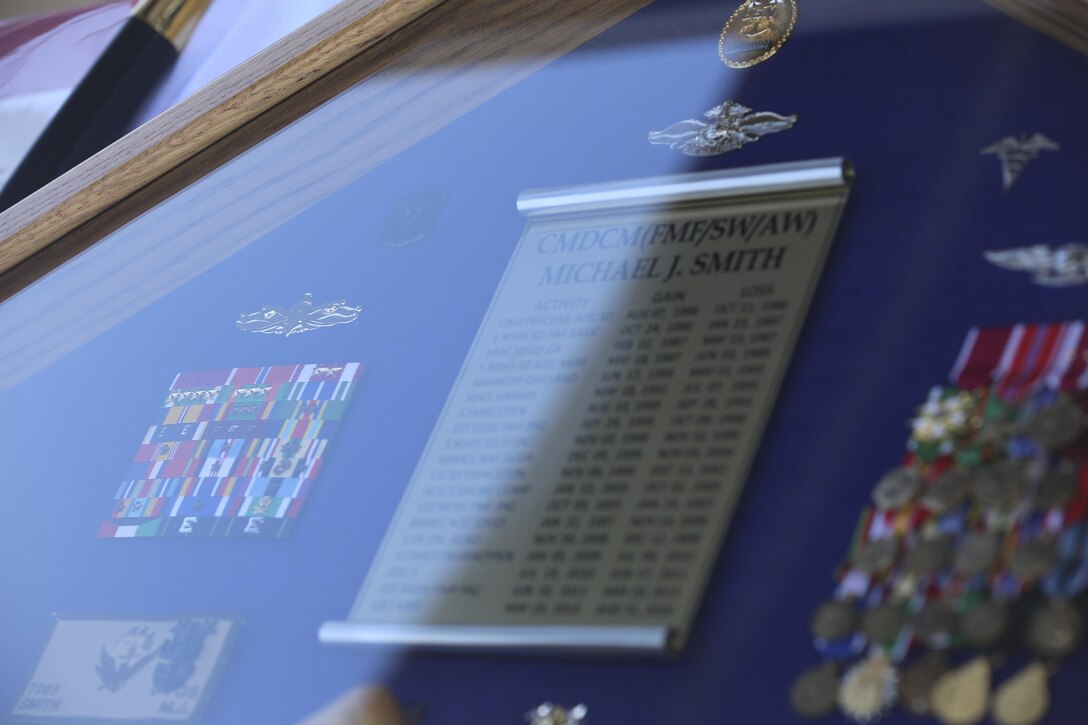 MARINE CORPS BASE CAMP PENDLETON, Calif. - The shadowbox of Master Chief Petty Officer Michael Smith, outgoing command master chief of I Marine Expeditionary Force, lies on display during his change of charge and retirement ceremony on Camp Pendleton, June 3, 2016. The shadowbox was a gift given to Smith by the Navy, which displays duty stations he served in, ribbons and medals he was awarded, and the insignias of the ranks he rose through. (U.S. Marine Corps Photo By Cpl. Garrett White/Released)