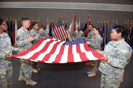 Staff Sgt. Angel Olivo, second from left, Information Technology Sergeant, 85th Support Command, trains the 85th Support Command incoming color guard members on the proper way to fold the American Flag during a flag folding ceremony.
(Photo by Spc. David Lietz)