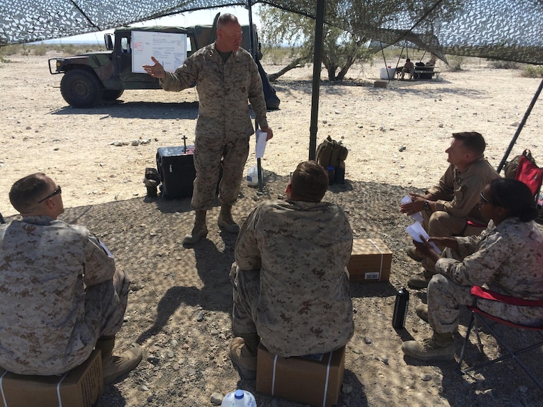 Lt. Cmdr. Paul Greer speaks to service members at a religous meeting during Weapons and Tactics Instructor Course 2-16 Field Exercises at Marine Corps Air Station Yuma, Ariz., March 27, 2016. Greer was recogized for the 2016 Military Chaplains Association Distinguished Service Award, and will recieve the award in Oct. 2016. The award recognizes one representative from each branch of service for their performance and dedication to the troops while serving as a chaplain. Greer is the chaplain for Marine Aircraft Control Group 28, and is the second 2nd MAW chaplain to win the award for the Marine Corps in the past two years. (U.S. Navy photo by Petty Officer 3rd Class Alexis McDaniel/Released)