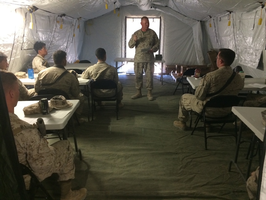 Lt. Cmdr. Paul Greer speaks to service members at a religous meeting during Weapons and Tactics Instructor Course 2-16 Field Exercise at Marine Corps Air Station Yuma, Ariz., March 27, 2016. Greer was recogized for the 2016 Military Chaplains Association Distinguished Service Award, and will recieve the award in Oct. 2016. The award recognizes one representative from each branch of service for their performance and dedication to the troops while serving as a chaplain. Greer is the chaplain for Marine Aircraft Control Group 28, and is the second 2nd MAW chaplain to win the award for the Marine Corps in the past two years. (U.S. Navy photo by Petty Officer 3rd Class Alexis McDaniel/Released)