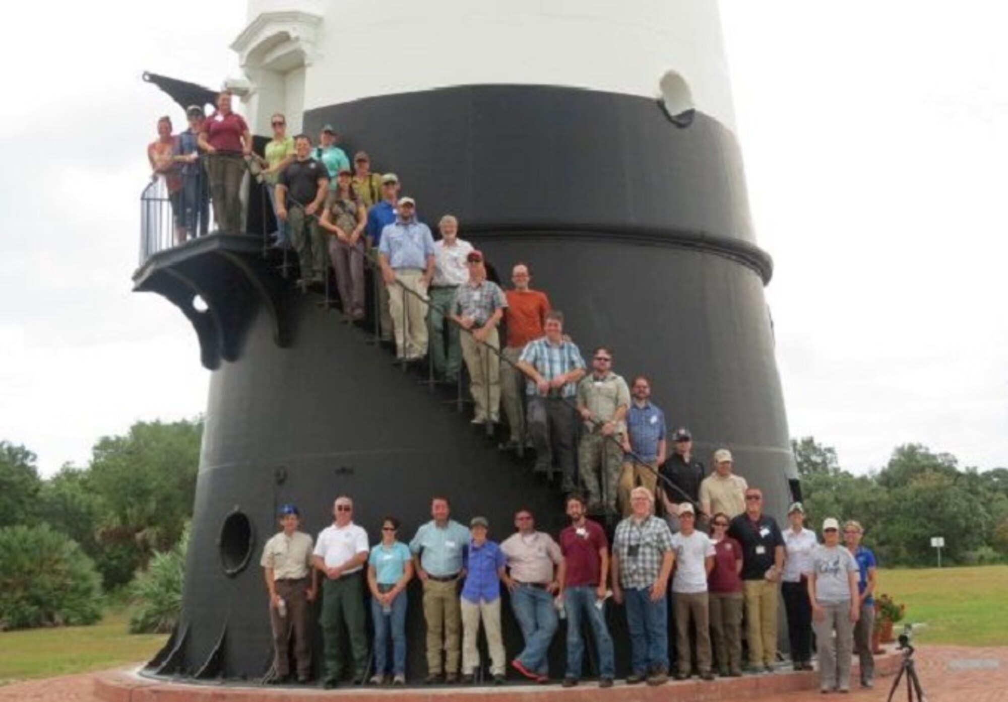 Members of the Gopher Tortoise Candidate Conservation Agreement team meeting pose for a photo at the Cape Canaveral Lighthouse at Cape Canaveral Air Force Station, Fla. June 7. The 45th Space Wing hosted the event here to show the group how they manage and protect gopher tortoise habitat on the Air Force's Eastern Range. Meeting participants from federal, state and the local agencies, as well other stakeholders are signing parties of the Candidate Conservation Agreement whose purpose to implement proactive gopher tortoise conservation measures across its eastern range which includes Florida, Georgia, Alabama and parts of South Carolina. (Courtesy photo)