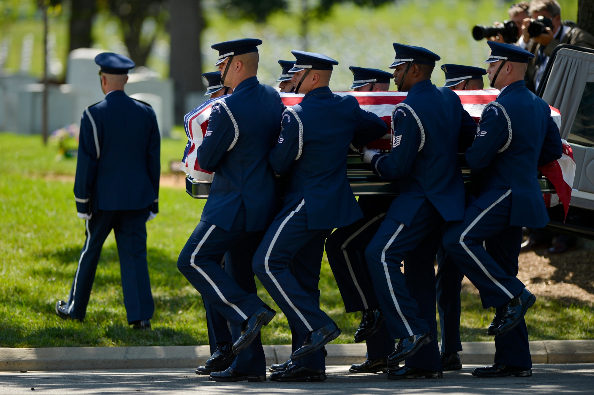 U.S. Air Force Honor Guard pallbearers carry former 2nd Lt. Malvin G. Whitfield, an Army Air Corps and Air Force veteran, to his burial site at Arlington National Cemetery in Arlington, Va., on June 8, 2016. Whitfield became the first active-duty U.S. military member to win gold medals in international track and field competitions when he competed at the 1948 Olympic Games in London, and in the 1951 Pan American Games. He died on Nov. 19, 2015, at the age of 91. (U.S. Air Force photo/Tech. Sgt. Joshua L. DeMotts)
