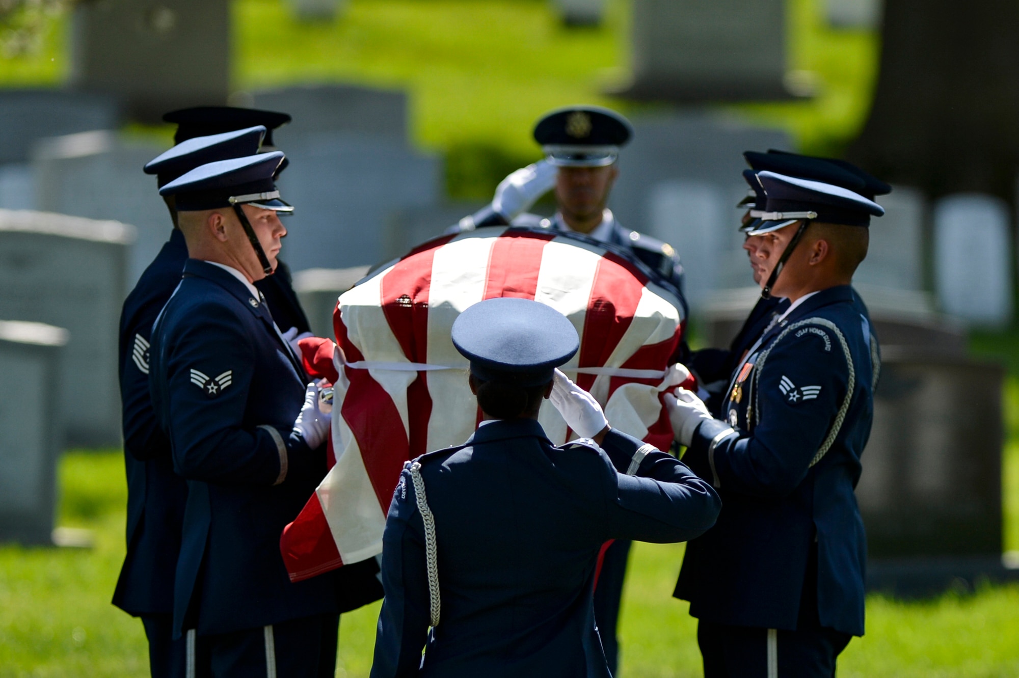 Members of the U.S. Air Force Honor Guard pay their final respects to former 2nd Lt. Malvin G. Whitfield during a graveside ceremony at Arlington National Cemetery in Arlington, Va., on June 8, 2016. Whitfield joined the Army Air Forces in 1943 as a Tuskegee Airman, one of more than 1,000 African-American pilots who fought in World War II. (U.S. Air Force photo/Tech. Sgt. Joshua L. DeMotts)