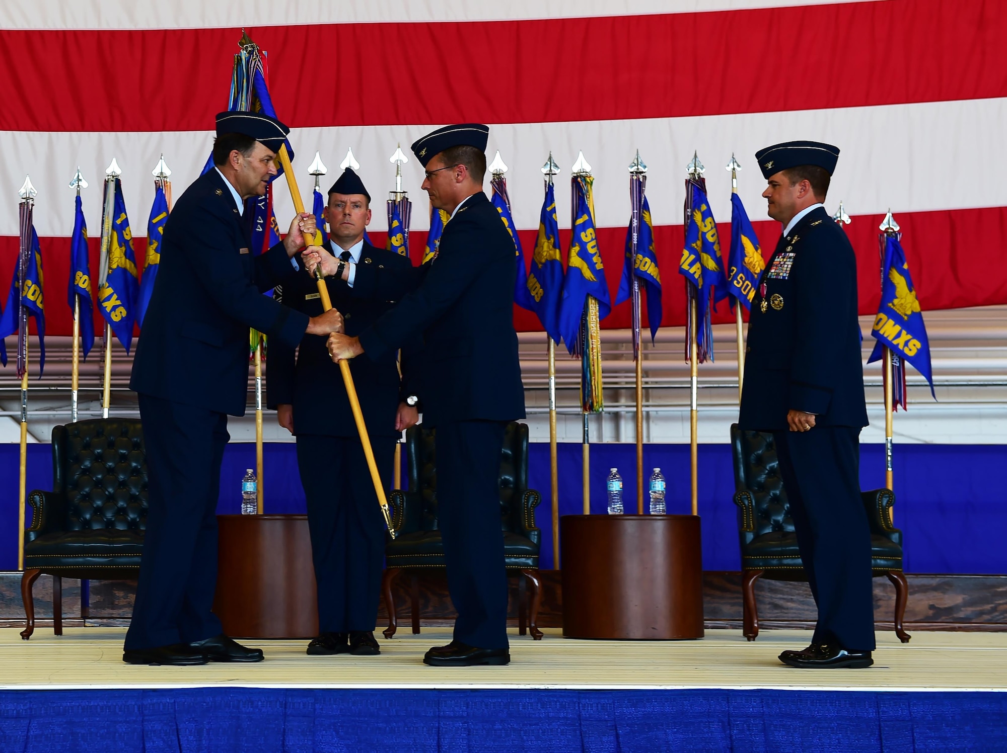 Col. Tom Palenske, commander of the 1st Special Operations Wing, takes the guidon from Lt. Gen. Brad Heithold, commander of Air Force Special Operations Command, to assume command of the 1st SOW during a change of command ceremony at Hurlburt Field, Fla., June 10, 2016. Upon taking command of the 1st SOW, Palenske will be responsible for preparing Air Force special operations forces for missions worldwide in support of Army, Navy, Marine and allied special operations forces and USAF counterparts. (U.S. Air Force photo by Senior Airman Andrea Posey)