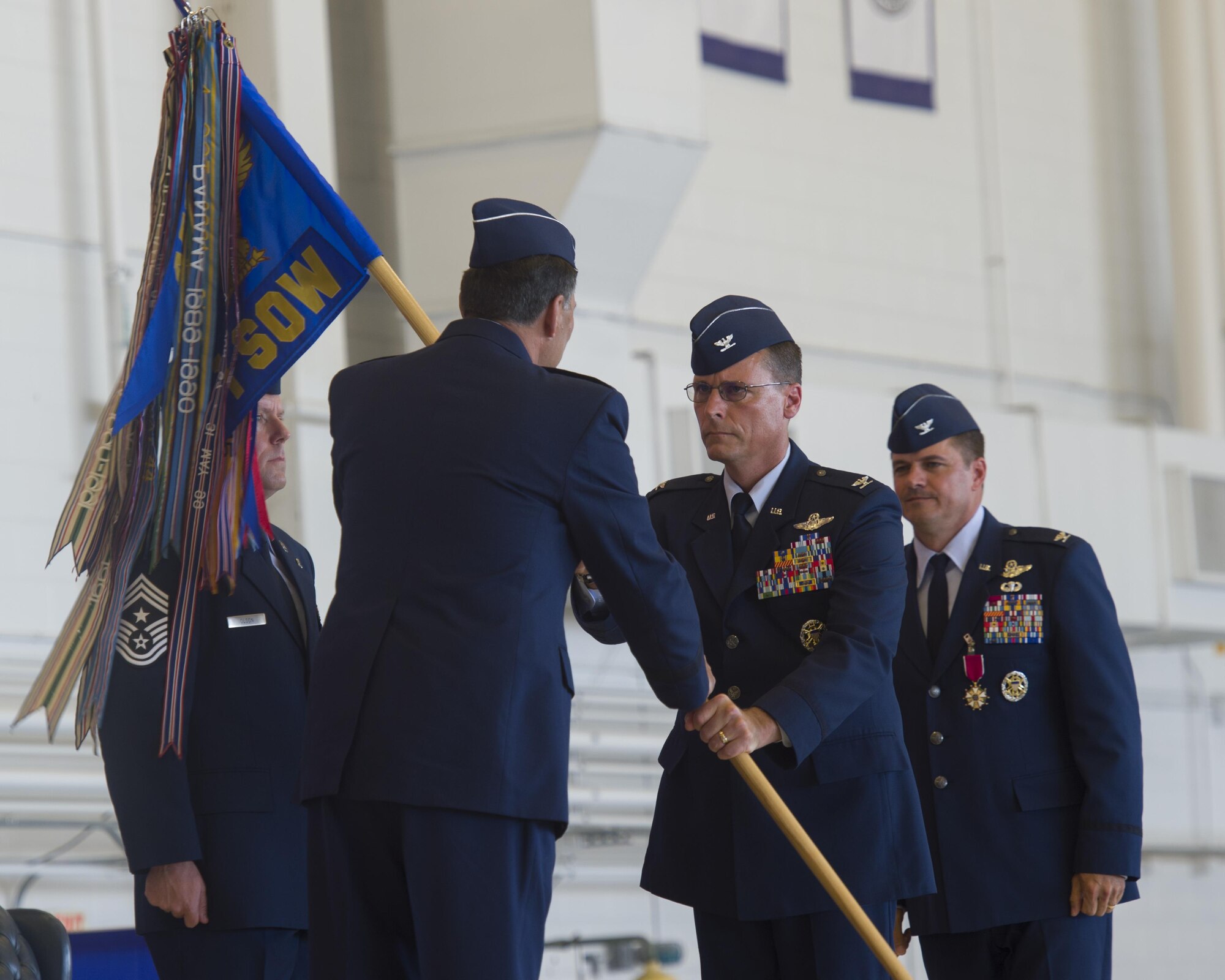 Col. Tom Palenske, commander of the 1st Special Operations Wing, takes the guidon from Lt. Gen. Brad Heithold, commander of Air Force Special Operations Command, to assume command of the 1st SOW during a change of command ceremony at Hurlburt Field, Fla., June 10, 2016. Upon taking command of the 1st SOW, Palenske will be responsible for preparing Air Force special operations forces for missions worldwide in support of Army, Navy, Marine and allied special operations forces and USAF counterparts. (U.S. Air Force photo by Airman 1st Class Kai White)