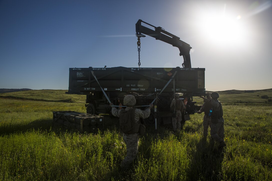 Marines with Battery F, 2nd Battalion, 14th Marines, 4th Marine Division, Marine Forces Reserve balance a rocket pod while offloading the unit from one truck to another before a High Mobility Artillery Rocket System test-fire at Fort Sill in Lawton, Okla., during their summer annual training exercise, “Iron Rage,” June 4, 2016.  Iron Rage consisted of conducting field operations with HIMARS and testing command and control proficiency at platoon and regimental levels in conjunction with other batteries from 14th Marines in Alabama and Texas. The HIMARS is the Marine Corps’ most advanced artillery system, and 2/14 is the only battalion in the Reserve component that is trained and mission capable with HIMARS alongside 5/11, 1st Marine Division, I Marine Expeditionary Force.