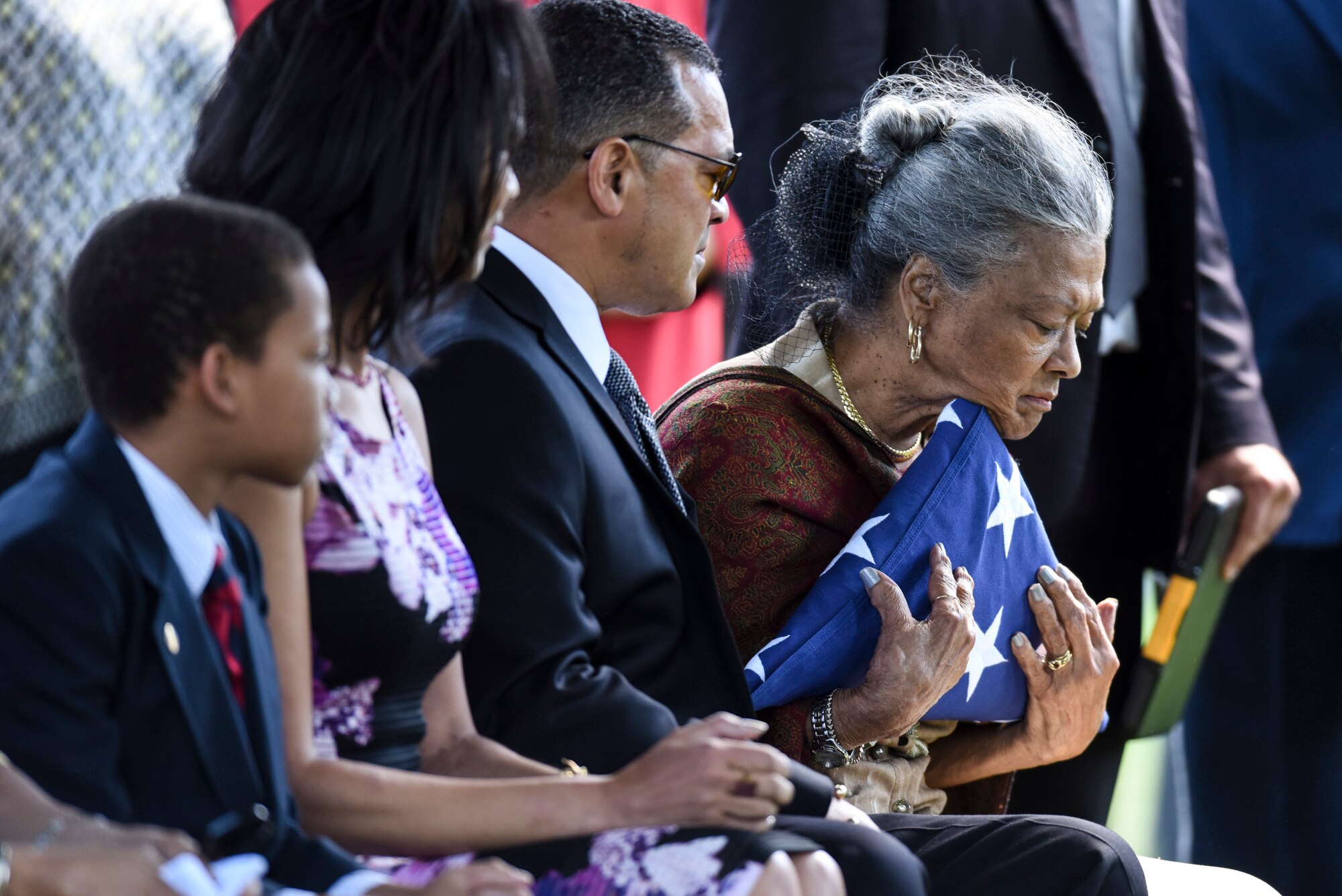 Nola Whitfield hugs the American flag that covered the casket of her husband, former 2nd Lt. Malvin G. Whitfield, during his graveside ceremony at Arlington National Cemetery, Va., June 8, 2016. Whitfield served in the Army Air Forces as a Tuskegee Airman, and is survived by his daughters Nyna Konishi and Fredricka Whitfield, son Malvin Whitfield Jr., and wife Nola Whitfield. (U.S. Air Force photo/Tech. Sgt. Anthony Nelson Jr.)