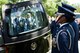 Capt. Kendra Gusme, a member of the U.S. Air Force Honor Guard, stands at attention while the casket carrying former 2nd Lt. Malvin G. Whitfield, an Army Air Forces and Air Force veteran, is removed from a hearse at Arlington National Cemetery, Va., June 8, 2016. Whitfield served in the Army Air Forces as a Tuskegee Airman, and later joined the Air Force Reserve as an officer. The honor guard provided full honors during the graveside service. (U.S. Air Force photo/Staff Sgt. Alyssa C. Gibson)