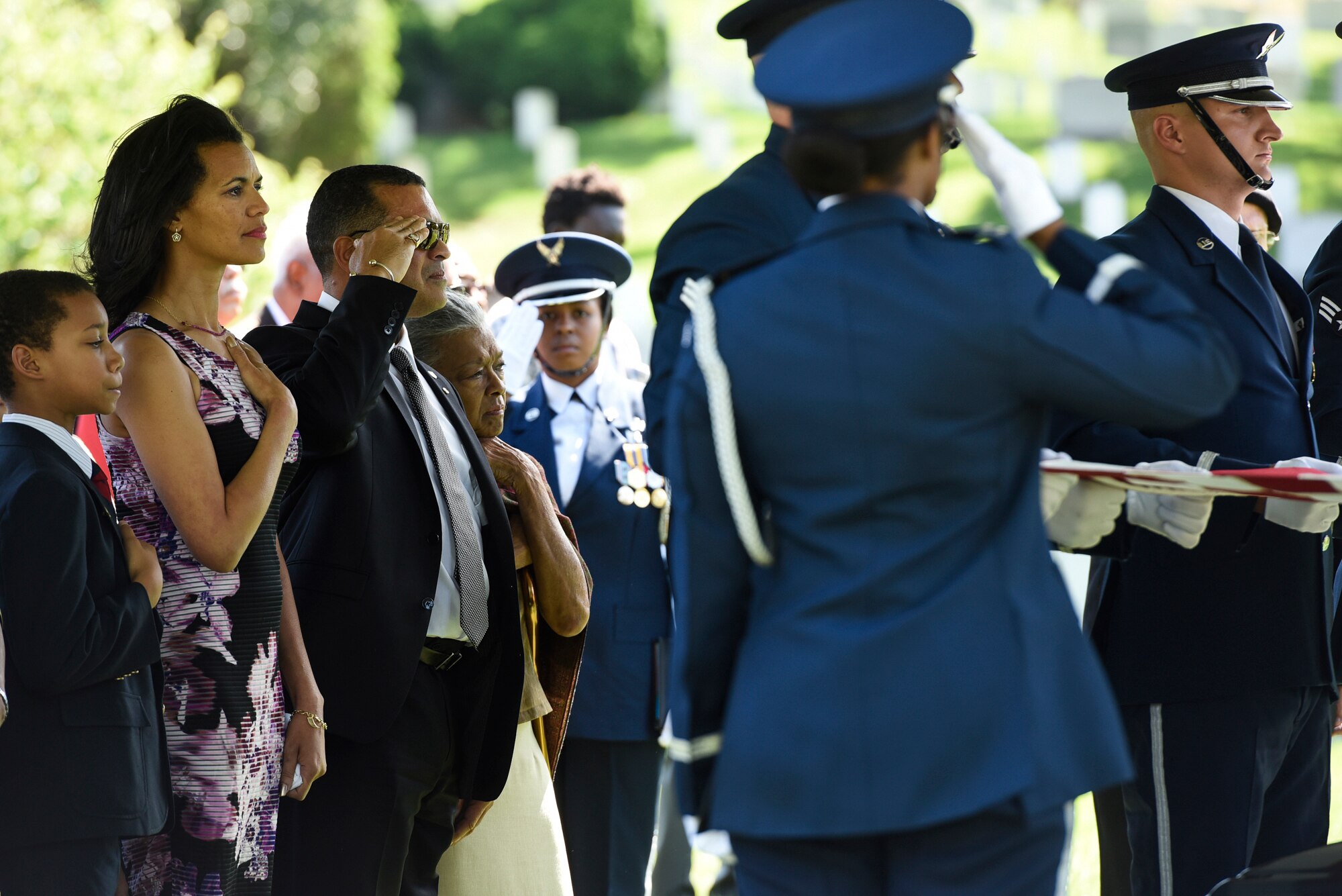 The family of former 2nd Lt. Malvin G. Whitfield, an Army Air Forces and Air Force veteran, stands during the playing of taps at Whitfield’s graveside ceremony at the Arlington National Cemetery, Va., June 8, 2016. He died Nov. 19, 2015, at the age of 91. (U.S. Air Force photo/Staff Sgt. Alyssa C. Gibson)