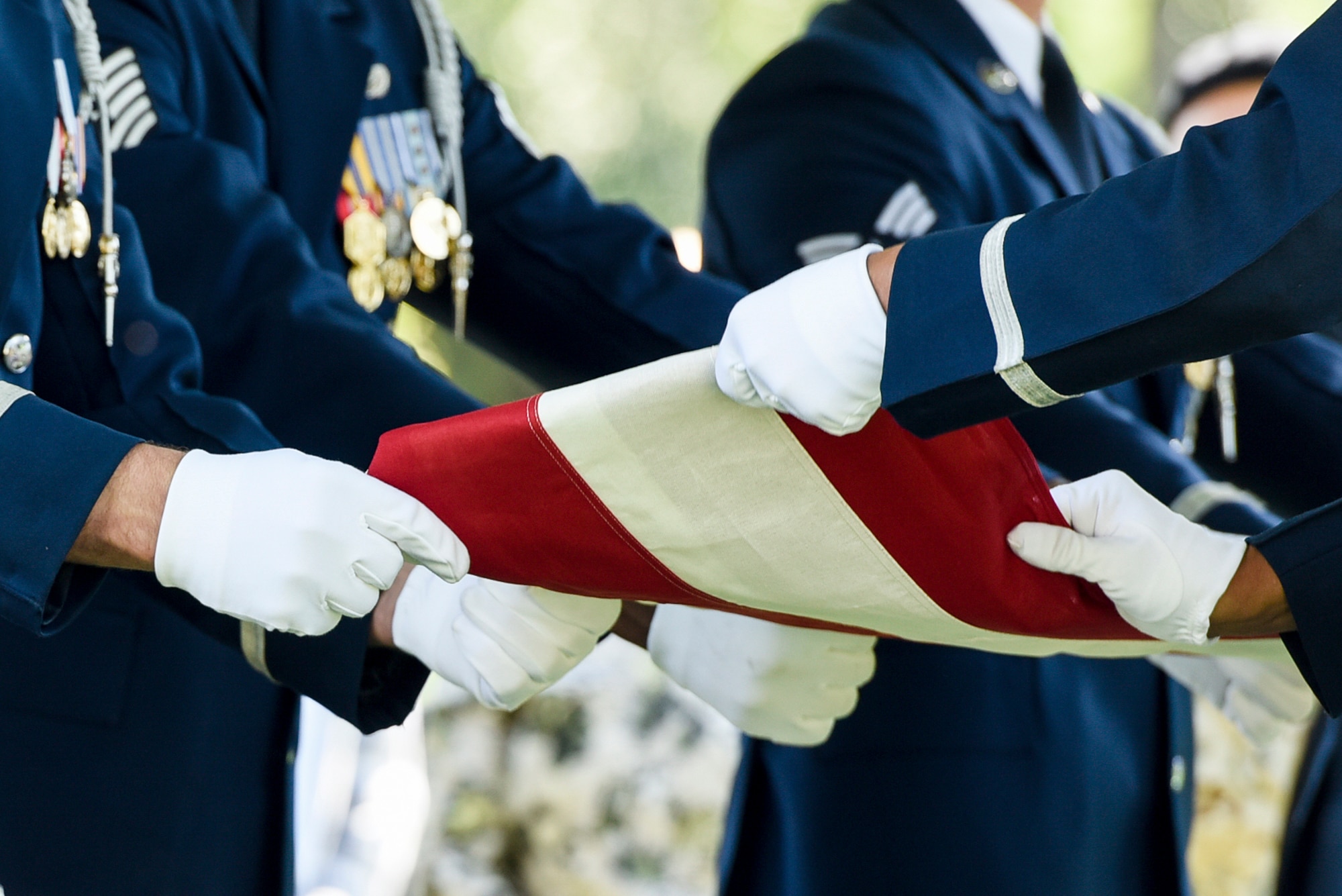 The U.S. Air Force Honor Guard folds the American flag during a graveside ceremony for former 2nd Lt. Malvin G. Whitfield at Arlington National Cemetery, Va., June 8, 2016. Whitfield joined the Army Air Forces in 1943 as a Tuskegee Airman, and later joined the Air Force Reserve as an officer. (U.S. Air Force photo/Staff Sgt. Alyssa C. Gibson)