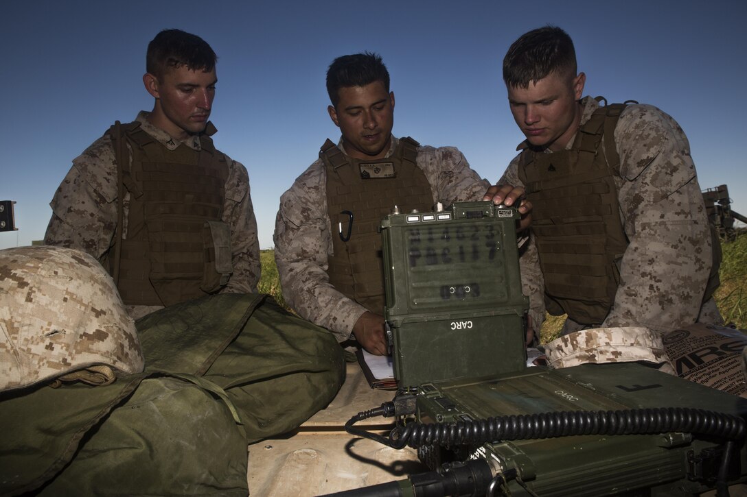 Staff Sgt. Anthony N. Rubio (center), communications chief for Battery F, 2nd Battalion, 14th Marines, 4th Marine Division, Marine Forces Reserve, teaches Marines the functions of a 117F multiband/multimission manpack radio, during their summer annual training exercise, “Iron Rage,” at Fort Sill in Lawton, Okla.,  June 5, 2016.  During Iron Rage, Marines conducted field operations with HIMARS and tested command and control proficiency at platoon and regimental levels in conjunction with other batteries from 14th Marines in Alabama and Texas.