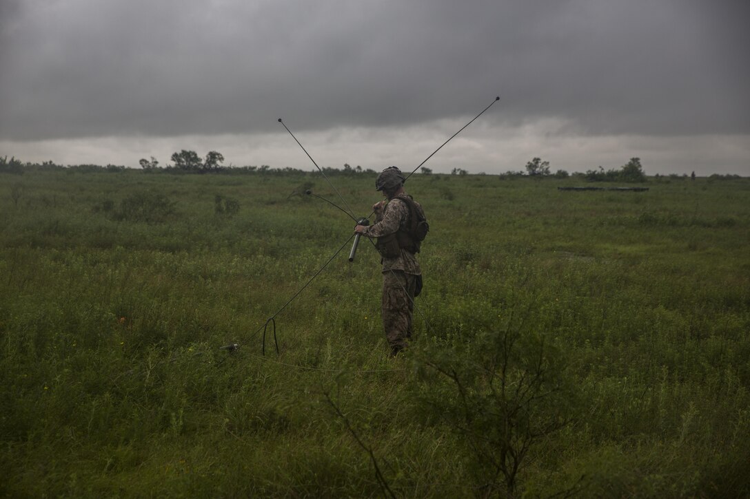 A Marine with Battery F, 2nd Battalion, 14th Marines, 4th Marine Division, Marine Forces Reserve, sets up an OE-254 communications antenna during his annual training at Fort Sill in Lawton, Okla., June 2, 2016.  To maintain a high level of readiness, the Marine Corps Reserve conducts annual training to ensure Marines remain proficient in their jobs as well as gain experience in other areas.