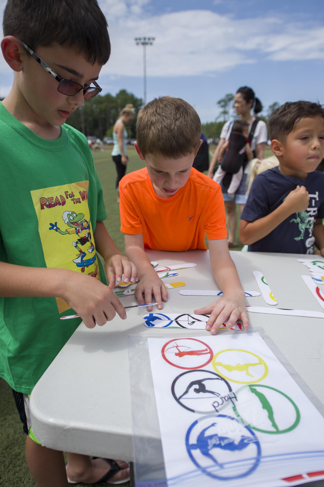 Hurlburt youth and their families participate in the library’s Summer Reading Program kickoff at Hurlburt Field, Fla., June 9, 2016. The program opened with a summer Olympics-themed event where Hurlburt youth participated in 10 activity stations. The stations combined mental and physical challenges to teach children about the importance of mental and physical training. (U.S. Air Force photo by Airman 1st Class Kai White)