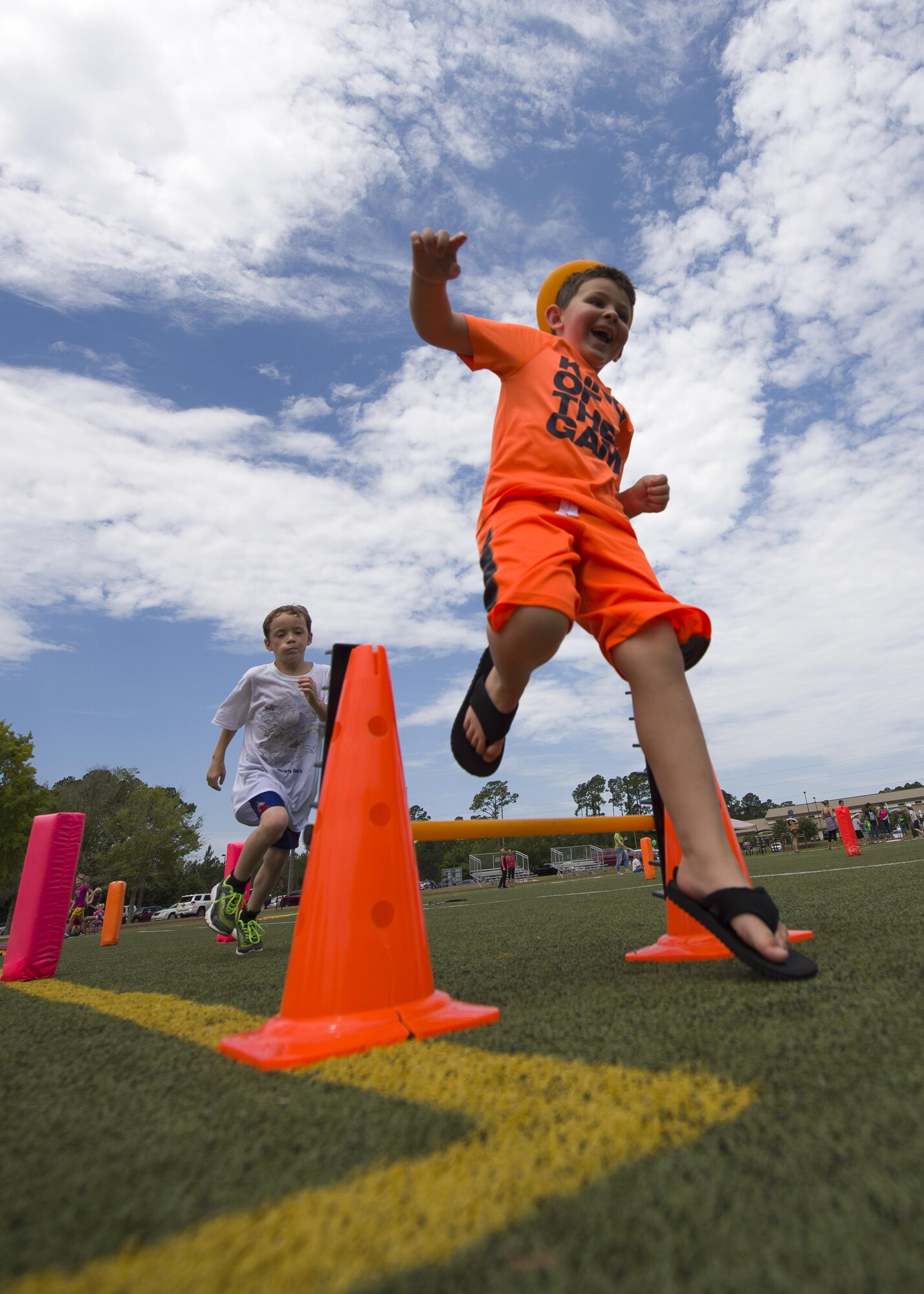 Children run through a training circuit during the library’s Summer Reading Program kickoff at Hurlburt Field, Fla., June 9, 2016. The program started off the month with a summer Olympics-themed event where Hurlburt youth participated in 10 activity stations. The stations combined mental and physical challenges to teach children about the importance of mental and physical training. (U.S. Air Force photo by Airman 1st Class Kai White)
