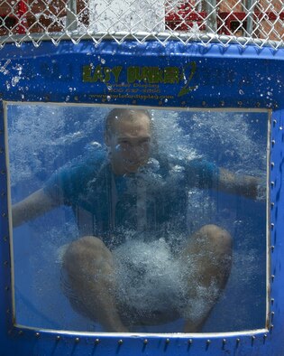 2nd Lt. Alan Erickson, 90th Force Support Squadron Community Services flight commander, takes a plunge inside a dunk tank June 8, 2016, during the Outdoor Recreation grand re-opening in the Fall Hall Commons on F.E. Warren Air Force Base, Wyo. The dunk tank was on display as one of the items people are able to rent from Outdoor Rec. for official functions. (U.S. Air Force photo by Senior Airman Brandon Valle)