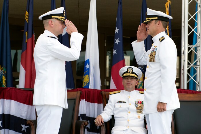 Commander Brett Pugsley (right) takes command of the Naval Consolidated Brig Charleston with a salute to his predecessor, Cmdr. J. Michael Cole, while Rear Adm. David Steindl, Commander of Navy Personnel Command, observes during a change of command ceremony June 10, 2016, at Joint Base Charleston S.C. Pugsley was previously the Brig’s executive officer. Cole who commanded the Brig for three years is retiring after 20 years of service. (U.S. Air Force photo/Staff Sgt. Jared Trimarchi)