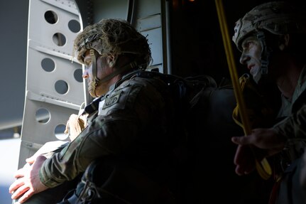 A Solider from the 82nd Airborne Division positions himself in front of the jump door while his jumpmaster looks on during an airdrop into Poland during Exercise Swift Response June 7, 2016. Cargo and U.S. Army and allied parajumpers were dropped into Poland as part of the exercise. Training alongside allies and fellow services allows AMC Airmen to prepare to execute rapid global mobility missions at any moment to any location in the world. (U.S. Air
Force photo/Staff Sgt. William A. O'Brien)
