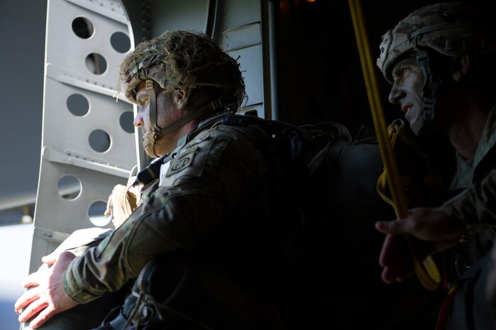 A Solider from the 82nd Airborne Division positions himself in front of the jump door while his jumpmaster looks on during an airdrop into Poland during Exercise Swift Response June 7, 2016. Cargo and U.S. Army and allied parajumpers were dropped into Poland as part of the exercise. Training alongside allies and fellow services allows AMC Airmen to prepare to execute rapid global mobility missions at any moment to any location in the world. (U.S. Air
Force photo/Staff Sgt. William A. O'Brien)