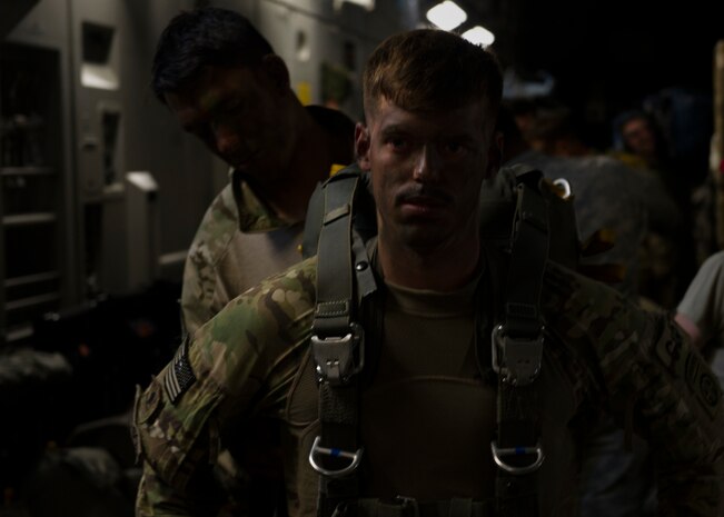 A Solider from the 82nd Airborne Division is outfitted with a parachute in preparation for an airdrop into Poland during Exercise Swift Response June 6, 2016. Aircraft from across the Air Mobility Command provided airlift and air refueling capabilities for the exercise. Training alongside allies and fellow services allows AMC Airmen to  prepare to execute Rapid Global Mobility missions at any moment to any location in the world. (U.S. Air Force photo/Staff Sgt. William A. O'Brien)
