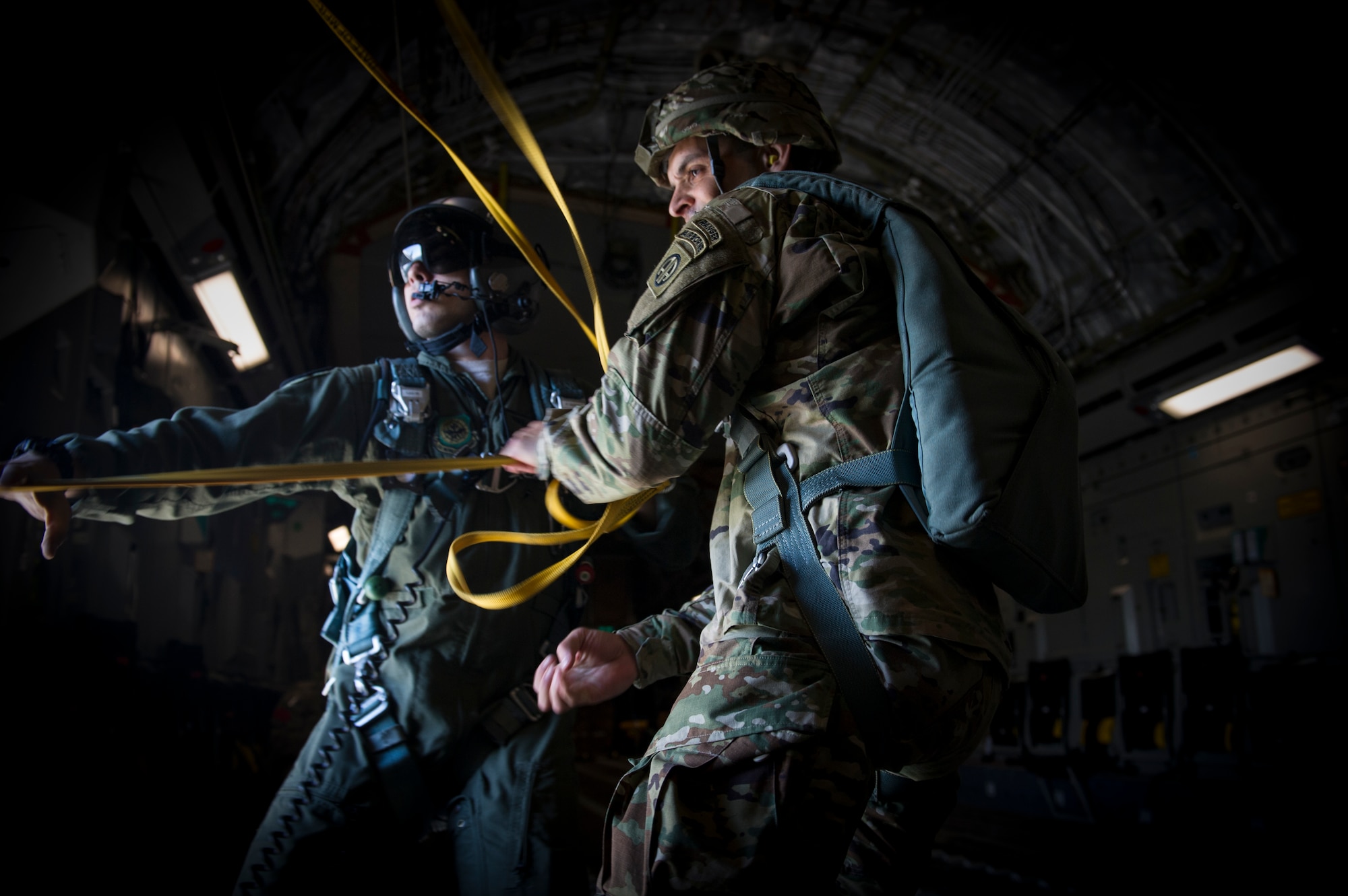 Staff Sgt. Will Favalora, 437 Airlift Wing loadmaster, assists 1st Lt. Jonathan Dieckman, 82nd Airborne Division jumpmaster, as he pulls parachute lines back into the aircraft following an airdrop into Poland as part of Exercise Swift Response June 6, 2016. Swift Response will exercise U.S. and Allied airborne forces’ ability to operate together as a high-readiness team. U.S. military forces routinely train alongside Allies and partners in Europe. These training events help to build a Europe that is strong, whole, free and at peace. (U.S. Air Force photo/Staff Sgt. William A. O'Brien) (U.S. Air Force photo/Staff Sgt. William A. O'Brien)