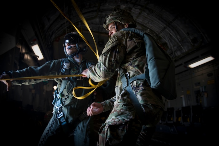 Staff Sgt. Will Favalora, 437 Airlift Wing loadmaster, assists 1st Lt. Jonathan Dieckman, 82nd Airborne Division jumpmaster, as he pulls parachute lines back into the aircraft following an airdrop into Poland as part of Exercise Swift Response June 6, 2016. Swift Response will exercise U.S. and Allied airborne forces’ ability to operate together as a high-readiness team. U.S. military forces routinely train alongside Allies and partners in Europe. These training events help to build a Europe that is strong, whole, free and at peace. (U.S. Air Force photo/Staff Sgt. William A. O'Brien) (U.S. Air Force photo/Staff Sgt. William A. O'Brien)