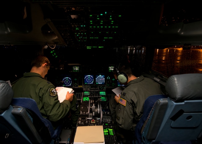 Capt. Chad Eva (left) and Capt. Chris Fleming (right), 437th Airlift Wing pilots, prepare for takeoff prior to an airlift as part of Exercise Swift Response June 6, 2016. Aircraft from across the Air Mobility Command provided airlift and air refueling capabilities for the exercise. The exercise tested U.S. and allied airborne forces' ability to operate together as a high-readiness team (U.S. Air Force photo/Staff Sgt. William A. O'Brien)