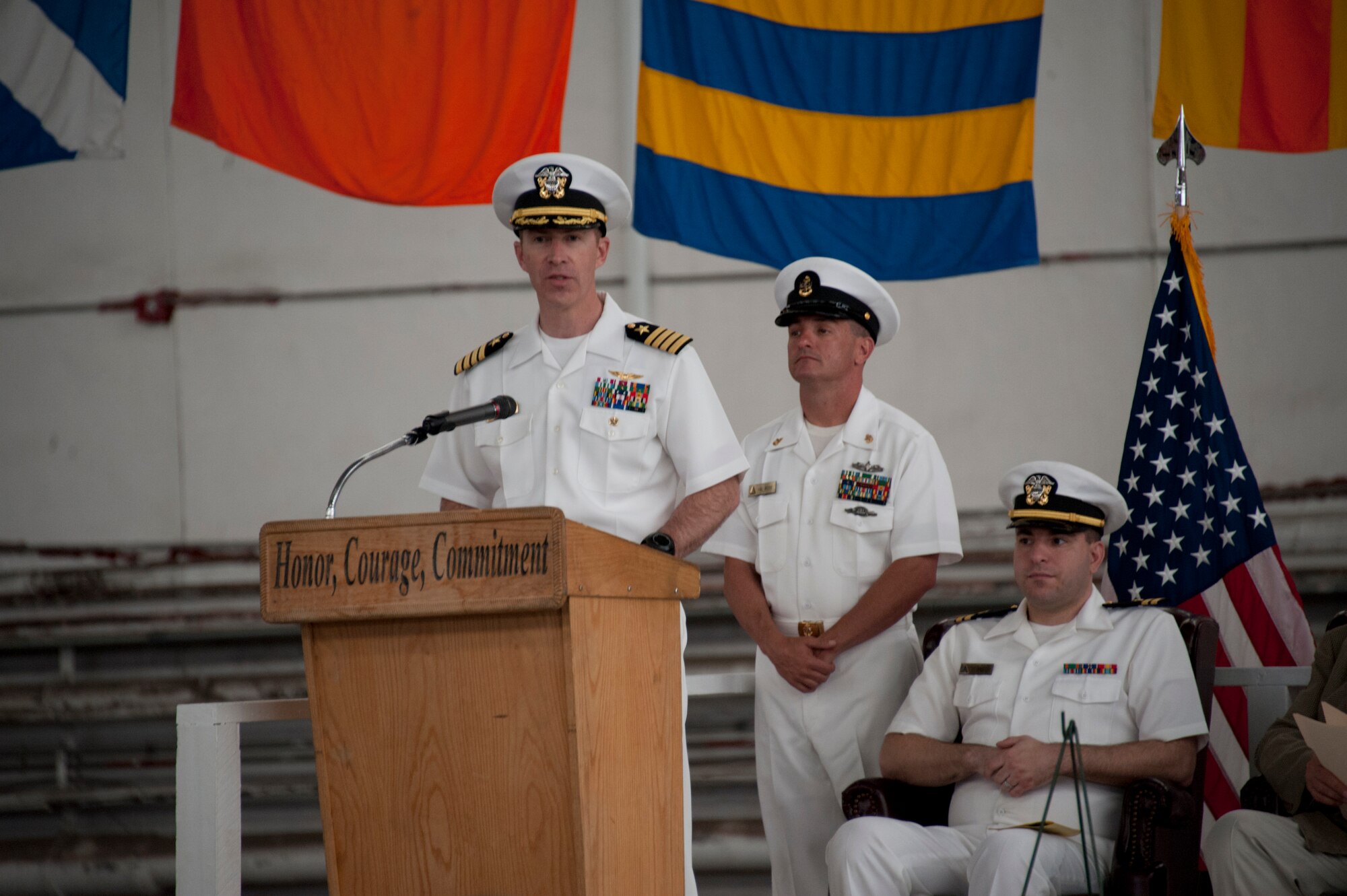 U.S. Navy Capt. Christopher Bergen, Naval Support Activity Lakehurst commander and Joint Base Deputy Commander Navy and host, addresses more than 300 military and community members aboard the flight deck in Hangar 1 during the 74th Commemoration ceremony of the Battle of Midway. (U.S. Air Force photo by Pascual Flores/Released)