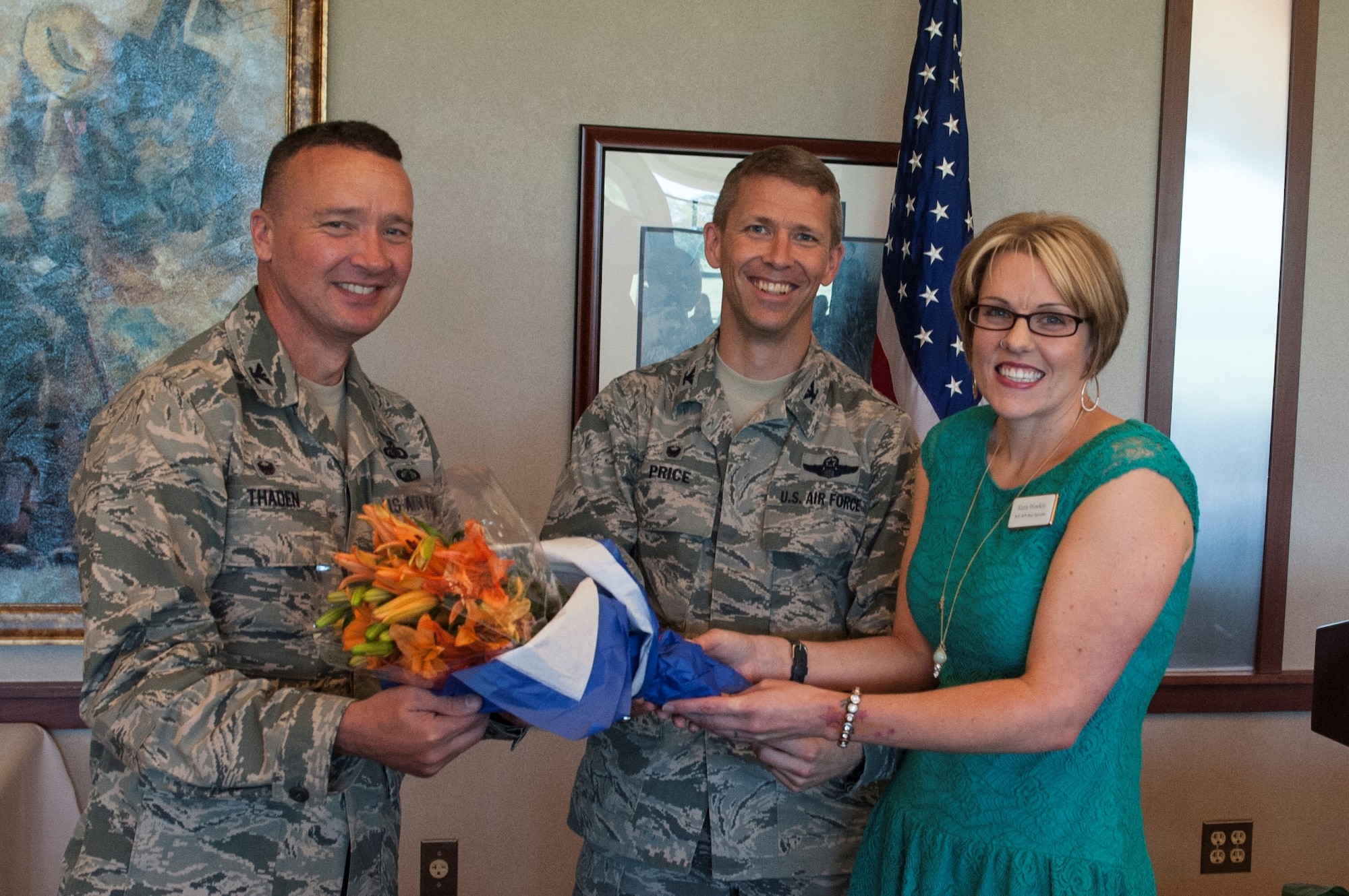 Col. Frederick Thaden, Joint Base MDL commander, and Col. John Price, 305th Air Mobility Wing commander, present Kara Weekly, Air Mobility Command’s 2015 Key Spouse of the Year, with flowers at the Key Spouse Appreciation Luncheon at the Falcon Creek Golf Course Clubhouse on Joint Base McGuire-Dix-Lakehurst, June 9, 2016. The event highlighted the MDL Key Spouses Program, a program designed to support families of deployed service members.