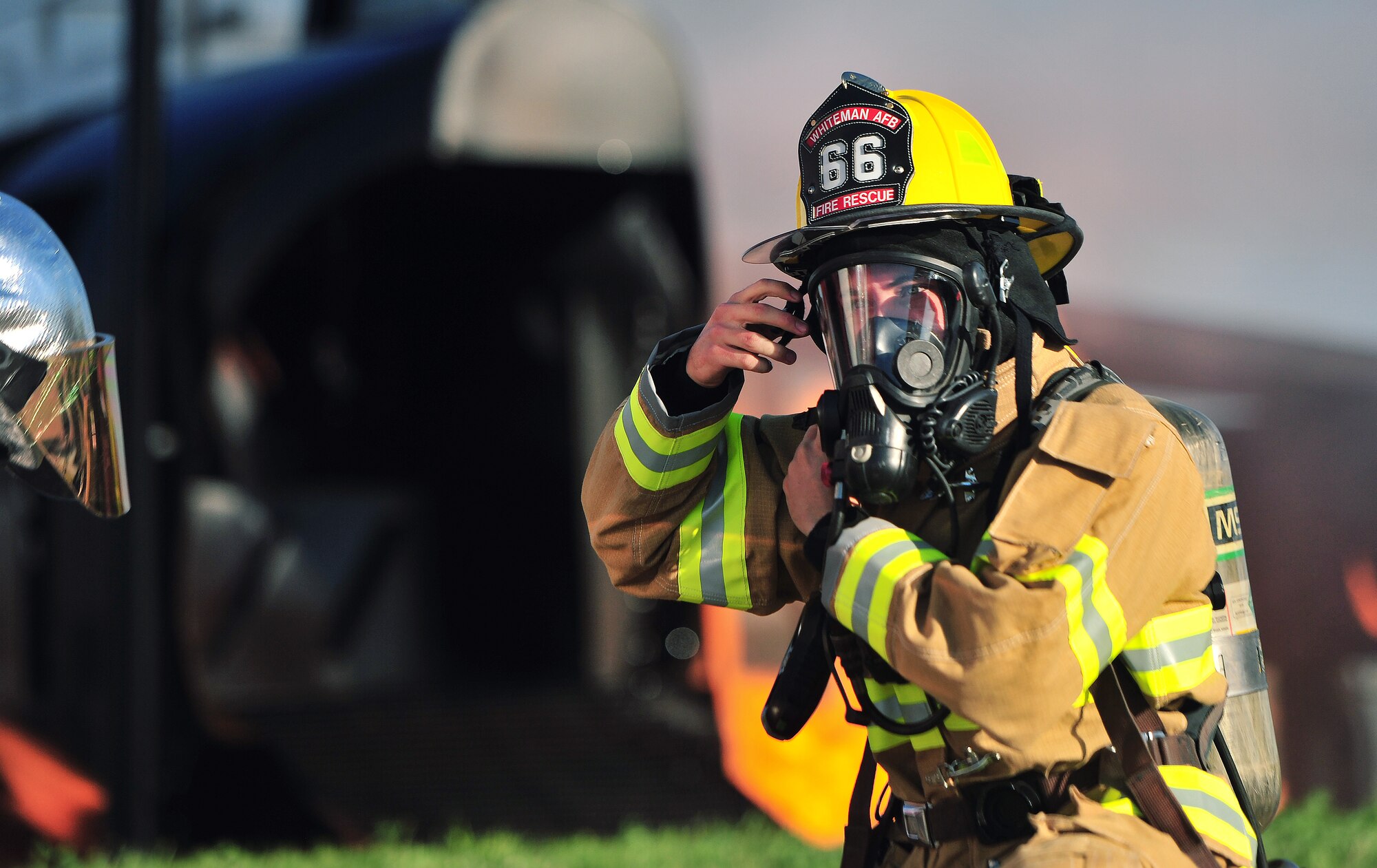 A firefighter from the 509th Civil Engineer Squadron makes adjustments to his gear prior to engaging with a simulated aircraft fire during a major accident response exercise (MARE) at Whiteman Air Force Base, Mo., June 8, 2016. The exercise is conducted to test readiness and response times in case of a major accident.  (US Air Force photo by Senior Airman Jovan Banks)