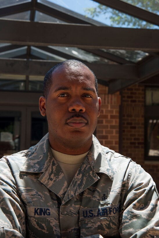 Tech. Sgt. Julius King, 11th Civil Engineer Squadron unaccompanied housing NCO in charge, stands in front of building 1657 at Joint Base Andrews, Md., June 9, 2016. As a dorm manager, King provides Airmen guidance and advice on UH life as well as mentorship on succeeding in the Air Force. (U.S. Air Force photo by Airman 1st Class Rustie Kramer/Released)
