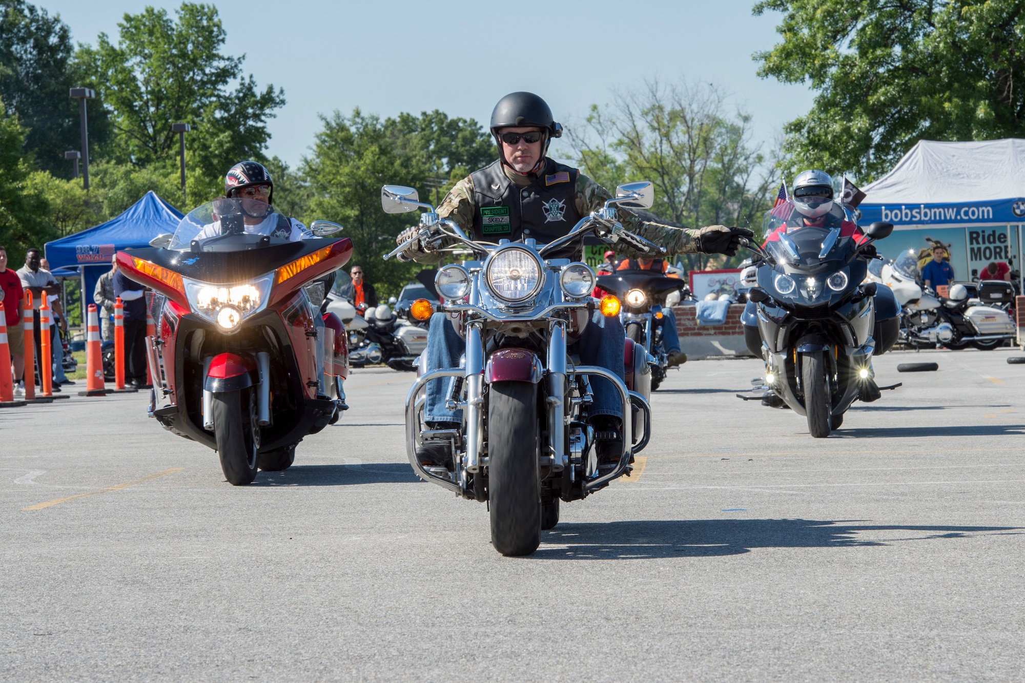 Members of he Green Knights’ Motorcycle Club demonstrate proper riding gestures during Motorcycle Safety Day on Joint Base Andrews, Md., June 9, 2016. These signals help the lead rider communicate possible hazards to fellow riders. (U.S. Air Force photo by Senior Airman Ryan J. Sonnier/RELEASED)
