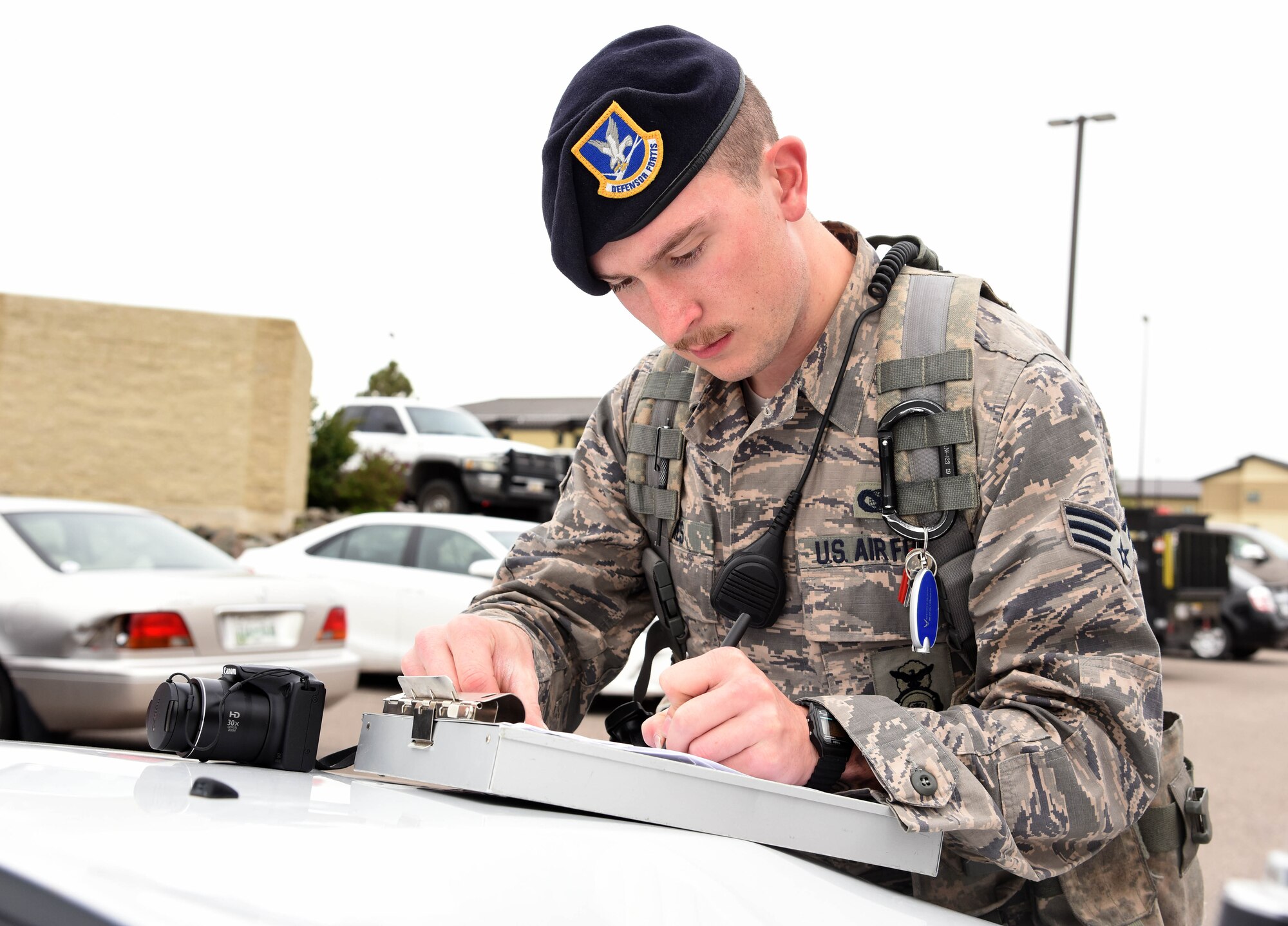 Senior Airman Jonathan James, 341st Security Forces Squadron installation patrolman, writes a citation May 23, 2016, at Malmstrom Air Force Base, Mont. James has been in the Air Force for five years, and joined because of the stories his grandfather, one of the first pararescumen, would tell him. (U.S. Air Force photo/Senior Airman Jaeda Tookes)