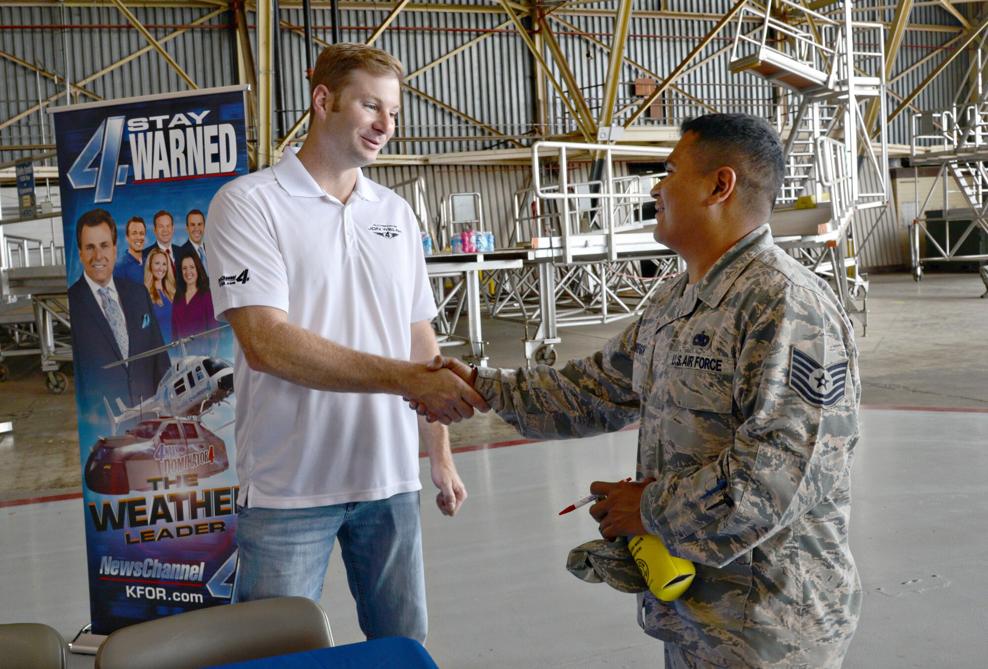 Tech. Sgt. Dennis Obregon, with the 752nd Operations Support Squadron, meets Bob Moore Chopper 4 pilot Jon Welsh with local news station KFOR, at the May 26 Safety Fair in Bldg. 230. (Air Force photo by Kelly White/Released)