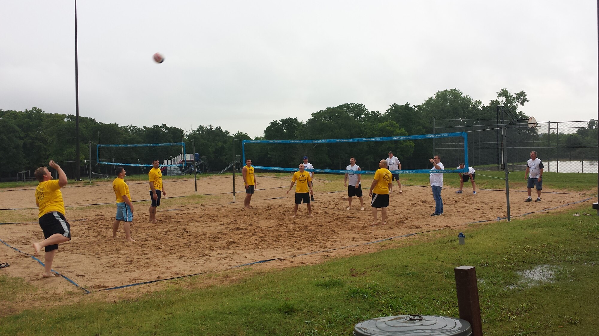 Adam Hawkins serves the ball during a casual match May 31 between Reserve White and Reserve Gold football teams to settle some scores over the outcome of the season (Reserve Gold won the football championship). The volleyball court is at the 38th Cyberspace Engineering Installation Group just east of Tinker Air Force Base. (Courtesy photo/Released)


