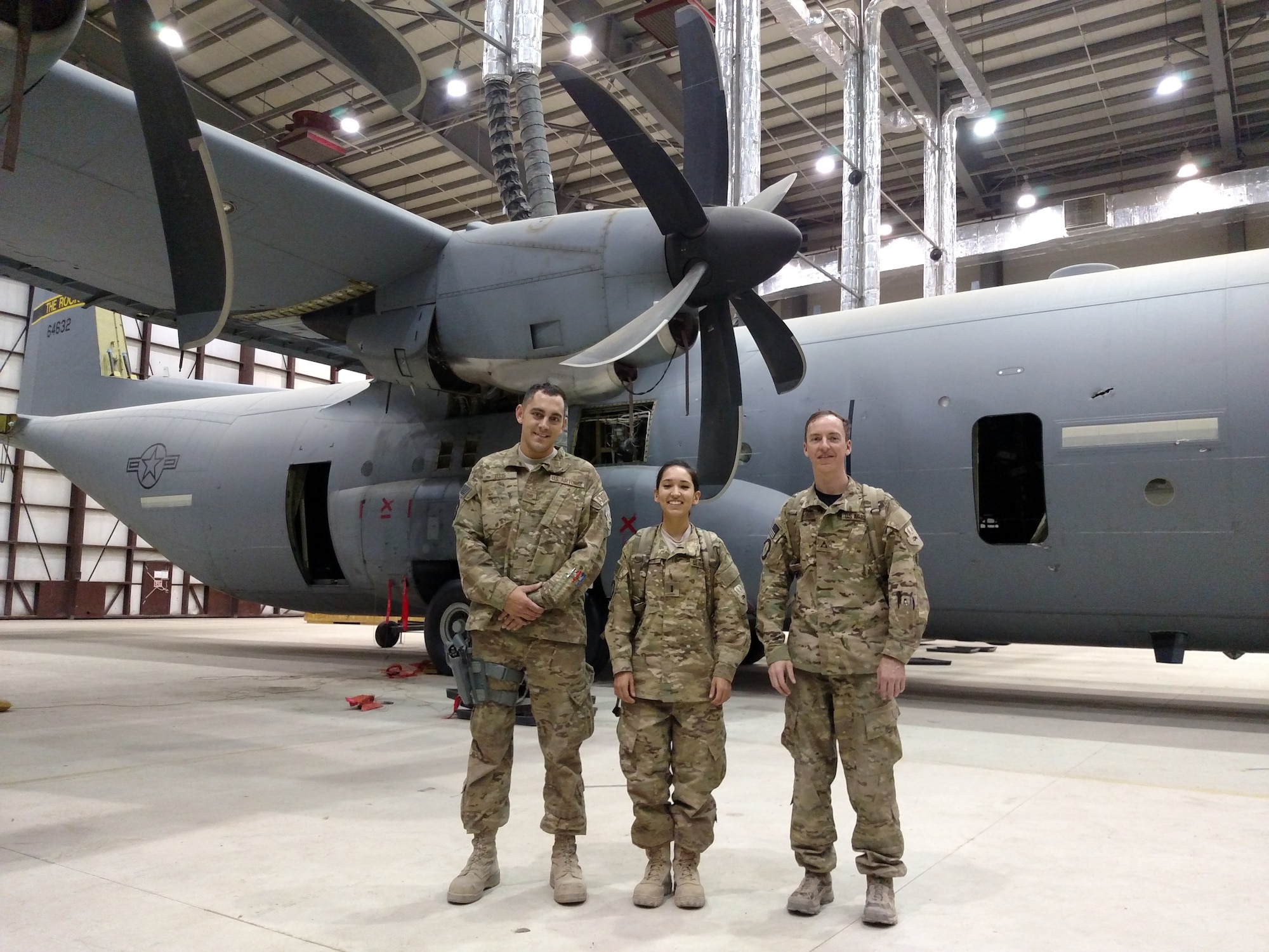 Experts from the Air Force Life Cycle Management Center’s Mobility Directorate pause for a break. The team was deployed to Afghanistan to help repair a C-130J aircraft that had been severely damaged by enemy fire. From left, Tech. Sgt. Nicholas Ellis, 1st Lt. Alexis Sanchez and Joel Lechene. (Courtesy photo)