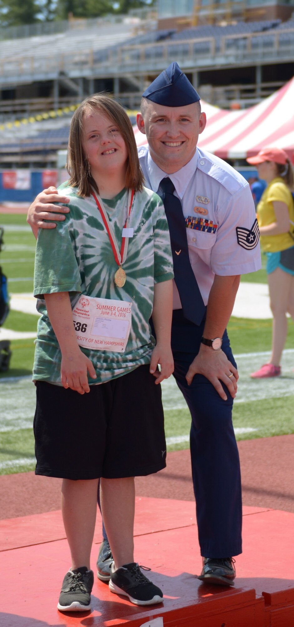 Tech. Sgt. William Cole congratulates and rewards a contestant of the 2016 Summer Special Olympics held at the University of New Hampshire June 4, 2016. Cole was volunteering for the first time at the Olympics where he was encouraging and providing support to all of the 2016 contestants. (U.S. Air National Guard photo by Senior Amn. Kayla McWalter)