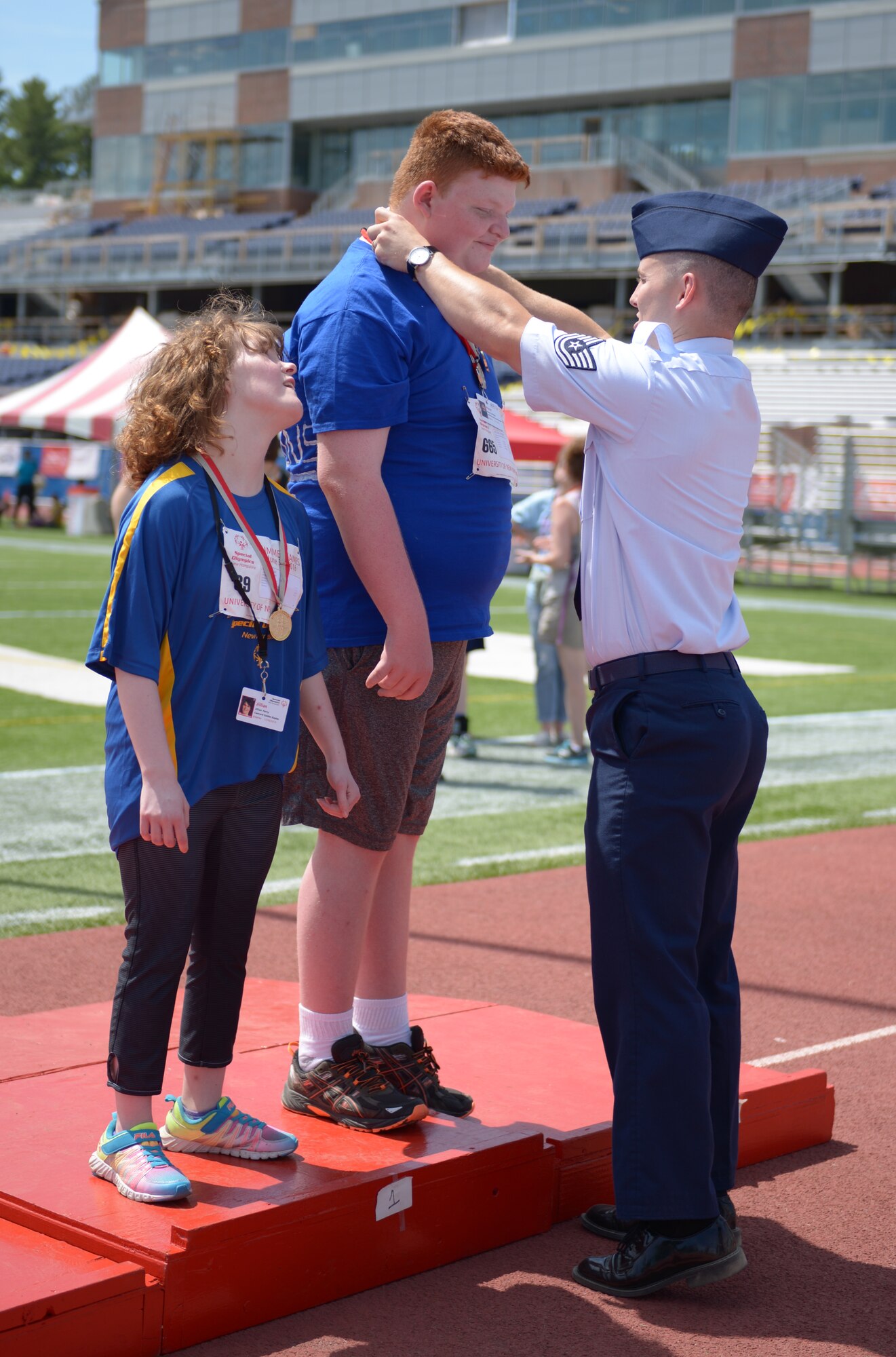 Tech. Sgt. William Cole congratulates and rewards a contestant of the 2016 Summer Special Olympics held at the University of New Hampshire June 4, 2016. Cole was volunteering for the first time at the Olympics where he was encouraging and providing support to all of the 2016 contestants. (U.S. Air National Guard photo by Senior Amn. Kayla McWalter)