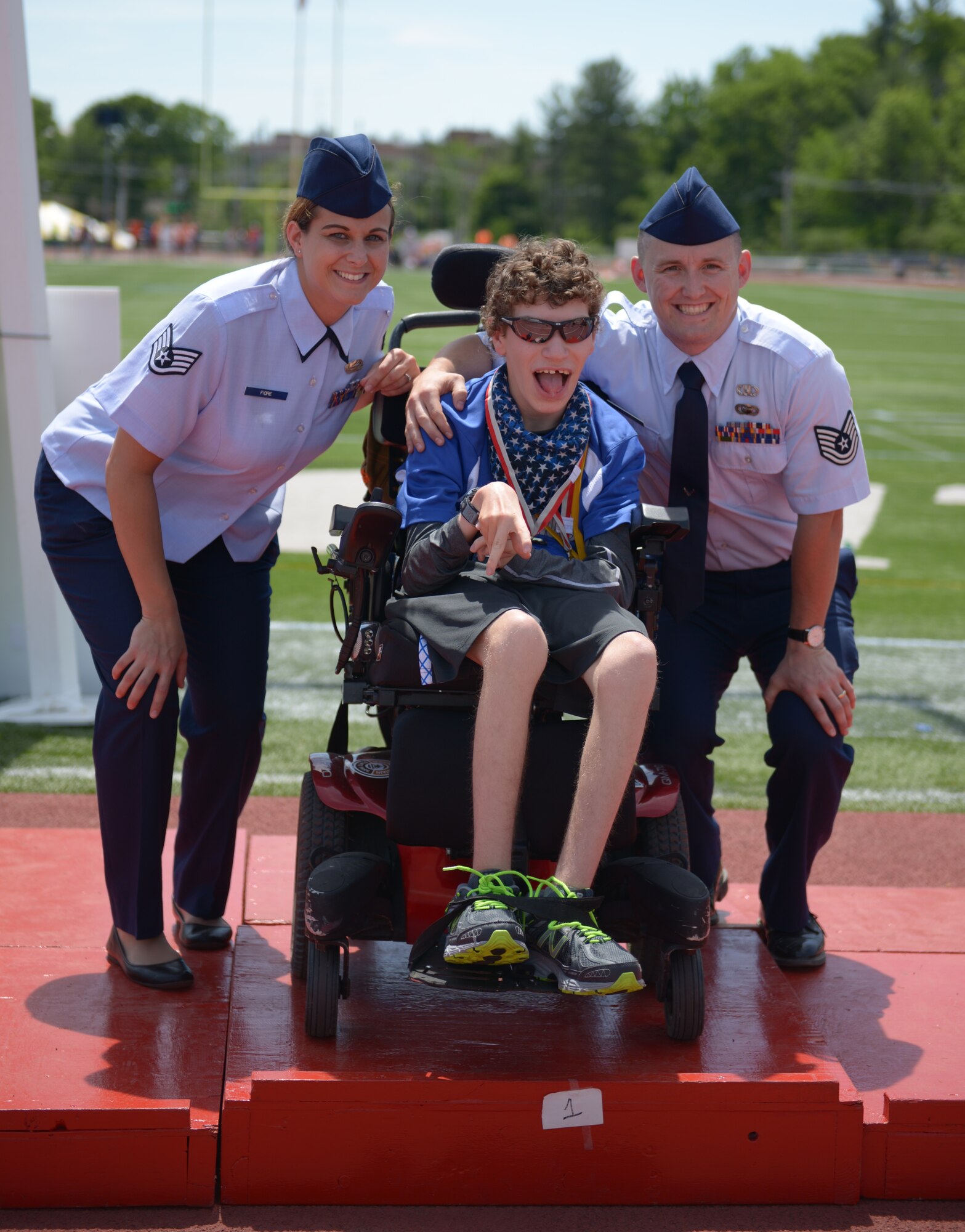 U.S. Air Force Staff Sgt. Taylor D. Fiore, 157th Mission Support Group personnel specialist and Tech. Sgt. William J. Cole, 157th Operations Group analyst, present medals to athletes during the New Hampshire Special Olympics Summer Games, June 4, 2016, University of New Hampshire, Durham, N.H. During the three day event, Airmen cheered and awarded the athletes in the top three categories. (U.S. Air National Guard photo by Senior Airman Kayla McWalter)
