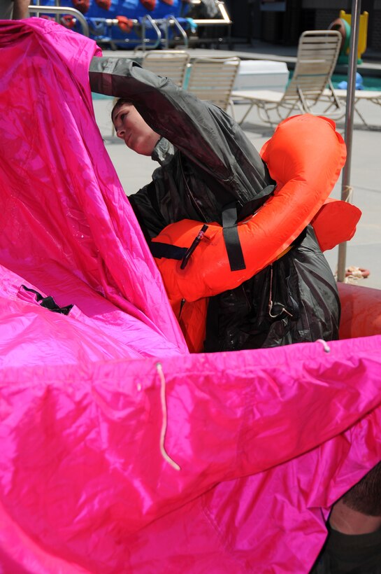 U. S. Air Force 1st Lt. Jackie Barrett with the 153rd Operations Group adjusts the canopy on a life raft during a water survival class at the Naval Construction Battalion Center Gulfport, Miss., June 8, 2016. Barrett and fellow air crew members utilized the water survival training as a skill refresher on survival techniques in the event of aircraft failure over water. (U. S. Air National Guard Photo by Tech. Sgt. Richard L. Smith/Released)