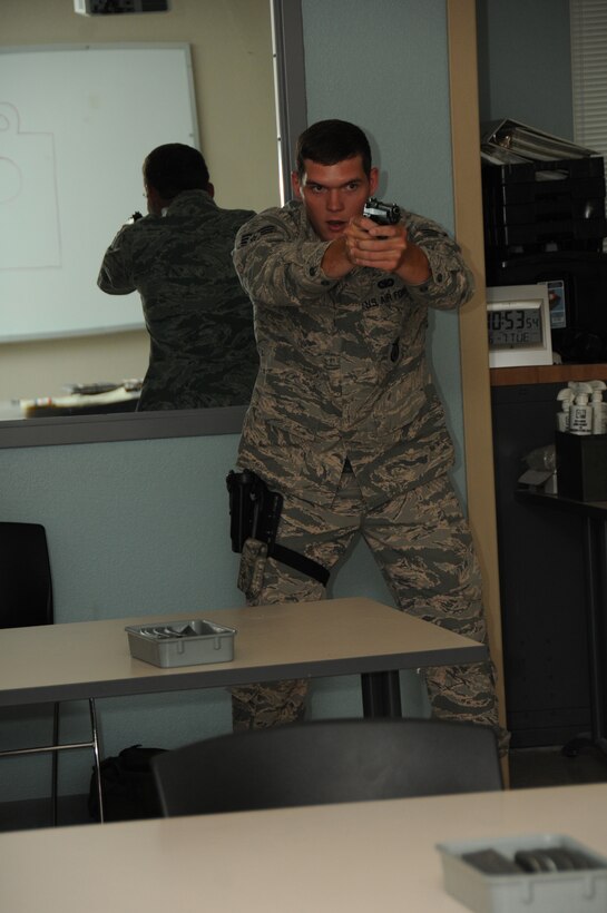 U. S. Air Force Senior Airman Joseph Lundy with the 186th Security Forces Squadron, demonstrates proper posture for firing the M9 pistol in the indoor firing range at Keesler Air Force Base, Biloxi, Miss., June 7, 2016. Lundy instructed 186th Air Refueling Wing Citizen Airmen how to operate, maintain and clear their firearms during weapons qualification. (U. S. Air National Guard Photo by Tech. Sgt. Richard L. Smith/Released)