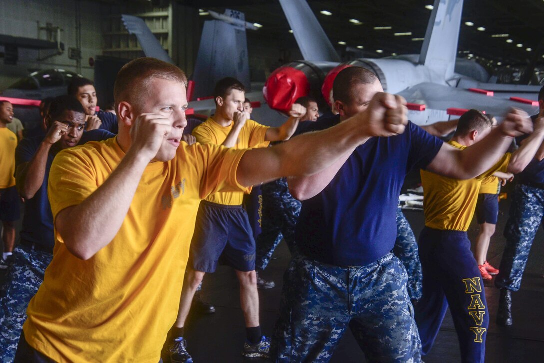 Sailors participate in security training in the hangar bay of the USS Dwight D. Eisenhower in the Atlantic Ocean, June 9, 2016. The aircraft carrier is conducting operations in the U.S. 6th Fleet area of responsibility to support U.S. national security interests in Europe. Navy photo by Seaman Dartez Williams